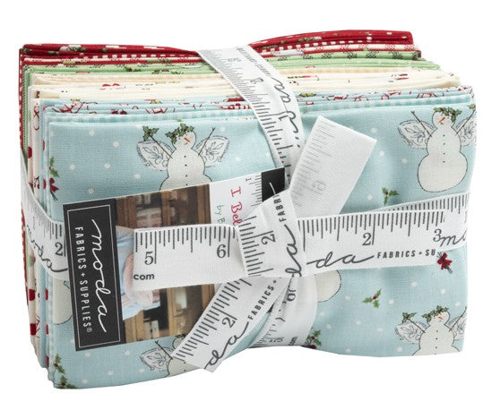 Bundle of fabric fat-eighths with snowman, angels and floral designs with a cloth measuring tape surrounding the bundle. Sold by Sewing Bee Studio.