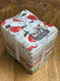 Bundle of fabric fat quarters with floral designs labeled as Christmas Eve by Moda. Sewing Bee Studio.
