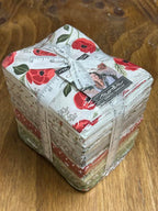 Bundle of fabric fat quarters with floral designs labeled as Christmas Eve by Moda. Sewing Bee Studio.