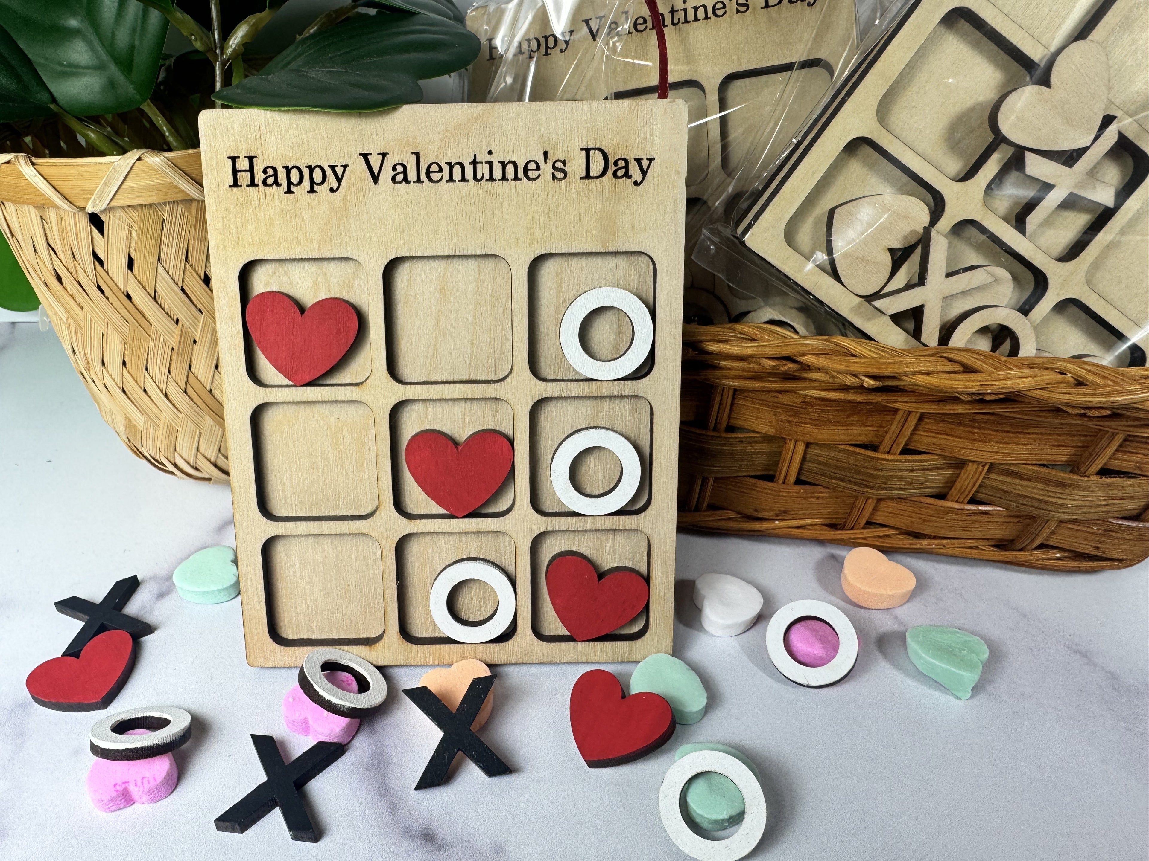 Valentine's Day-themed wooden game with hearts and circles on a marble surface.