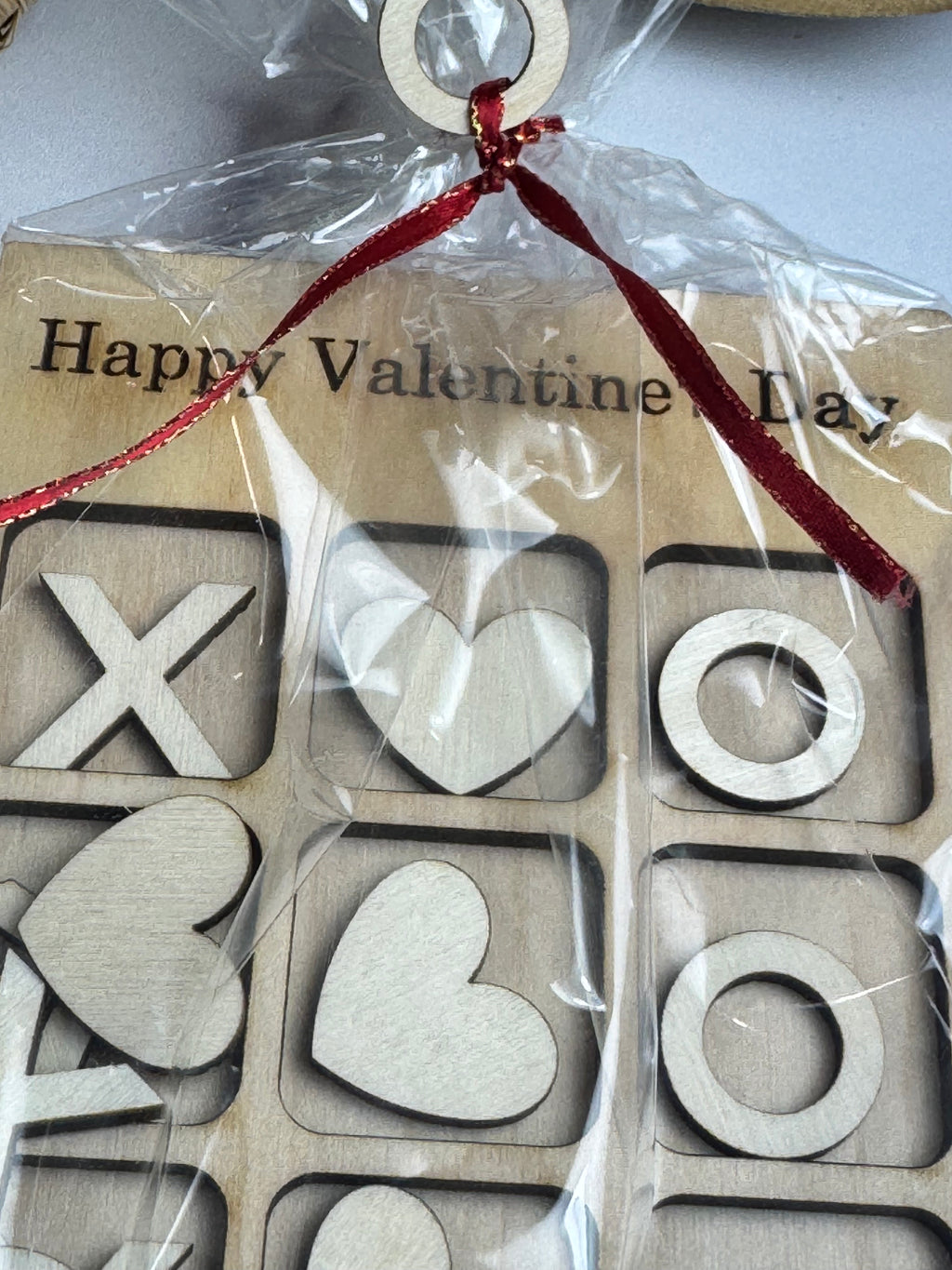 Wooden Valentine's Day decorations with hearts and crosses in a clear  Sewing Bee Studio package. Sewing Bee Studio 
