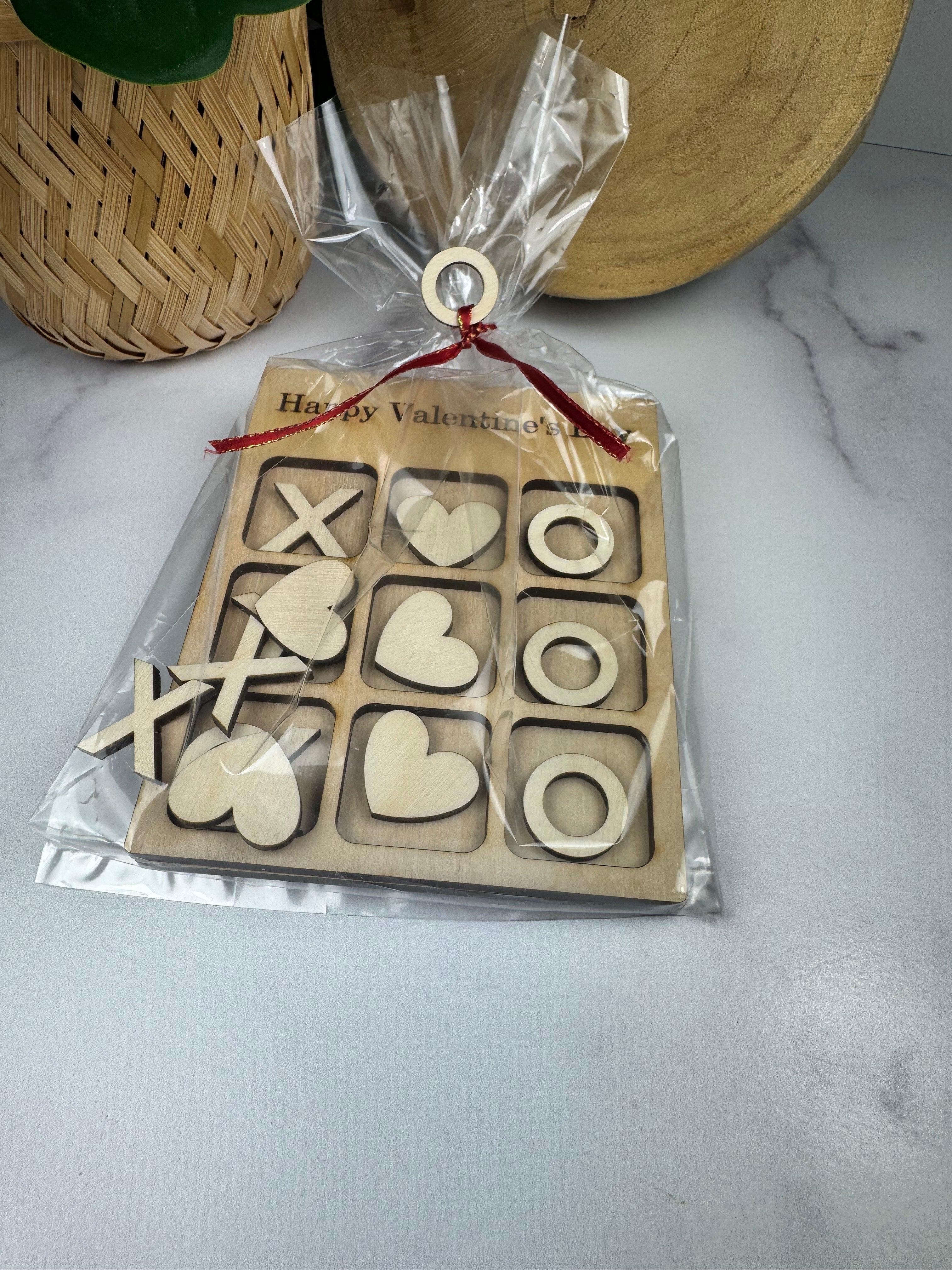 Wooden puzzle with heart and circle shapes in a clear package on a marble surface. Sewing Bee Studio 