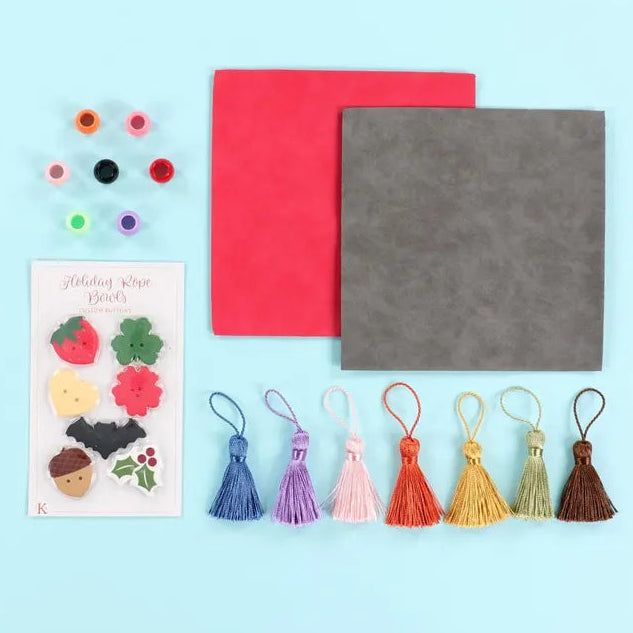 Colorful tassels and decorative items on a light blue background (Sewing Bee Studio)