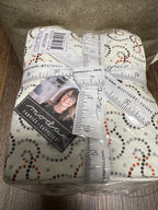 Packaged fabric with ruler design and MoLa label on a wooden surface